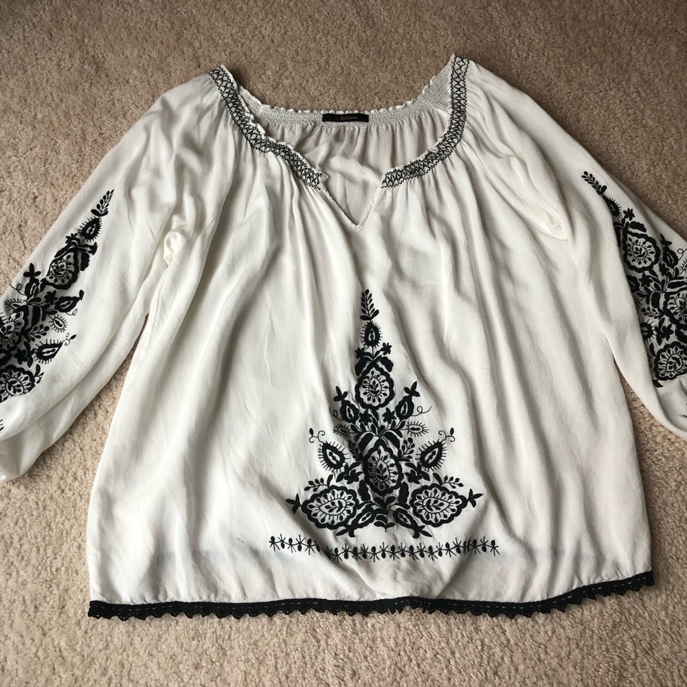 Embroidered black and white tunic with bell sleeves.